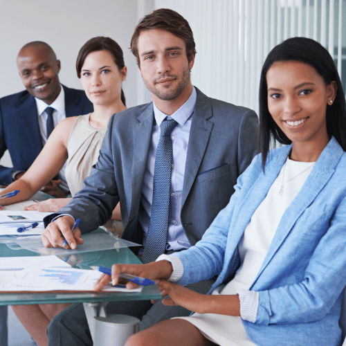 People at a work conference table looking professional.